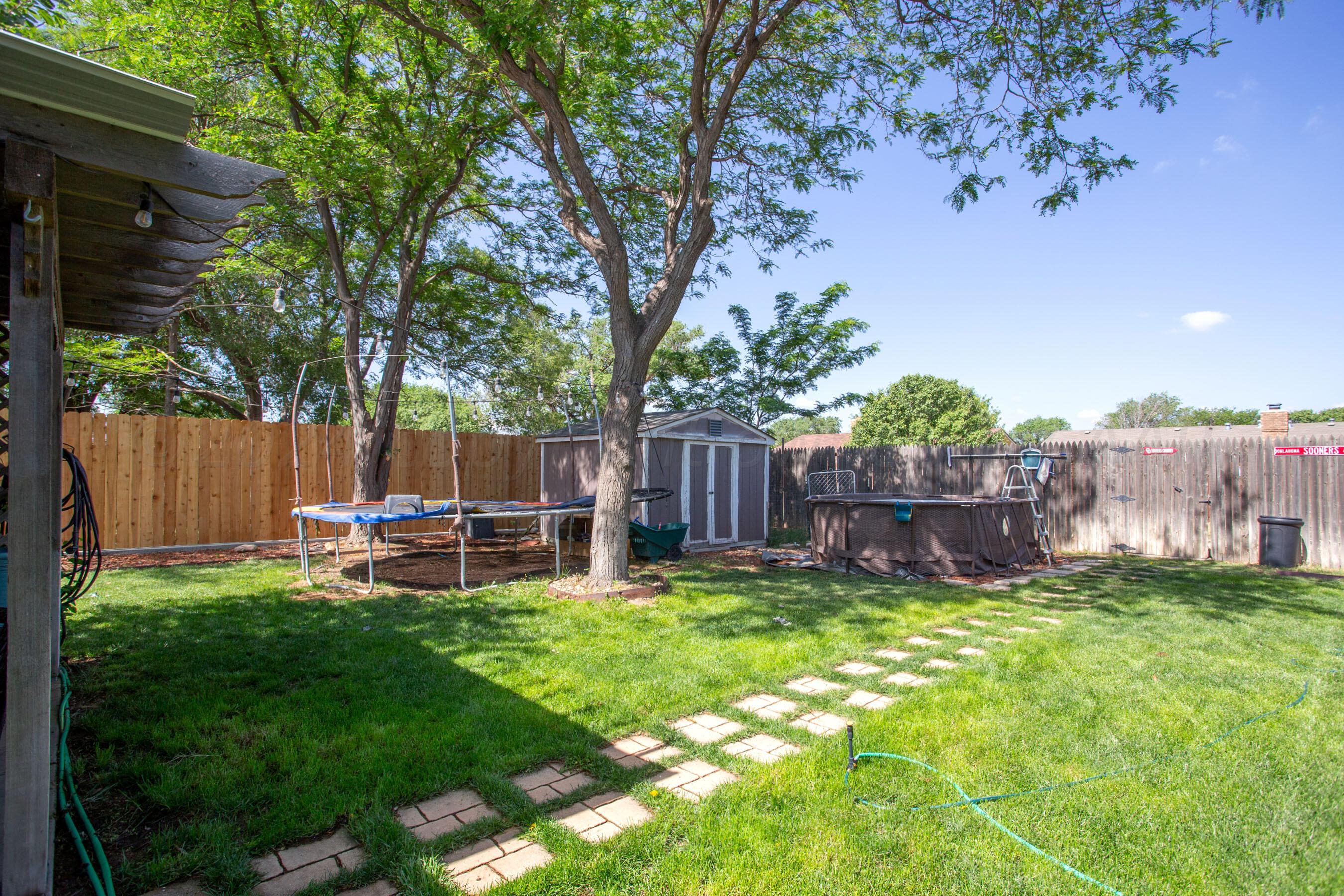 8122 Santa Fe Trail Amarillo, TX 79110 - Photo 19 of 23 a view of a chair and table in backyard of the house