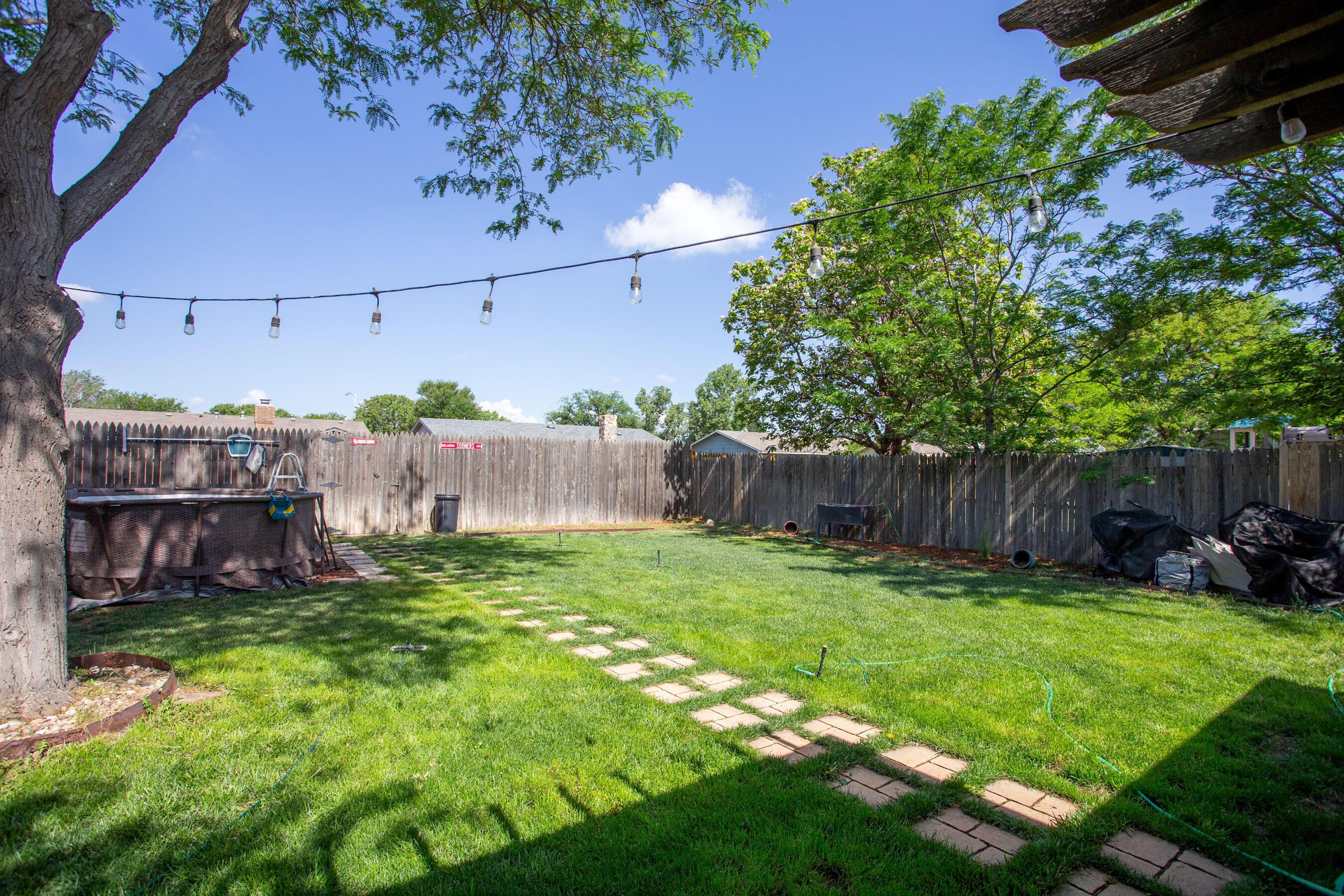 8122 Santa Fe Trail Amarillo, TX 79110 - Photo 21 of 23 a view of backyard with small cabin and wooden fence