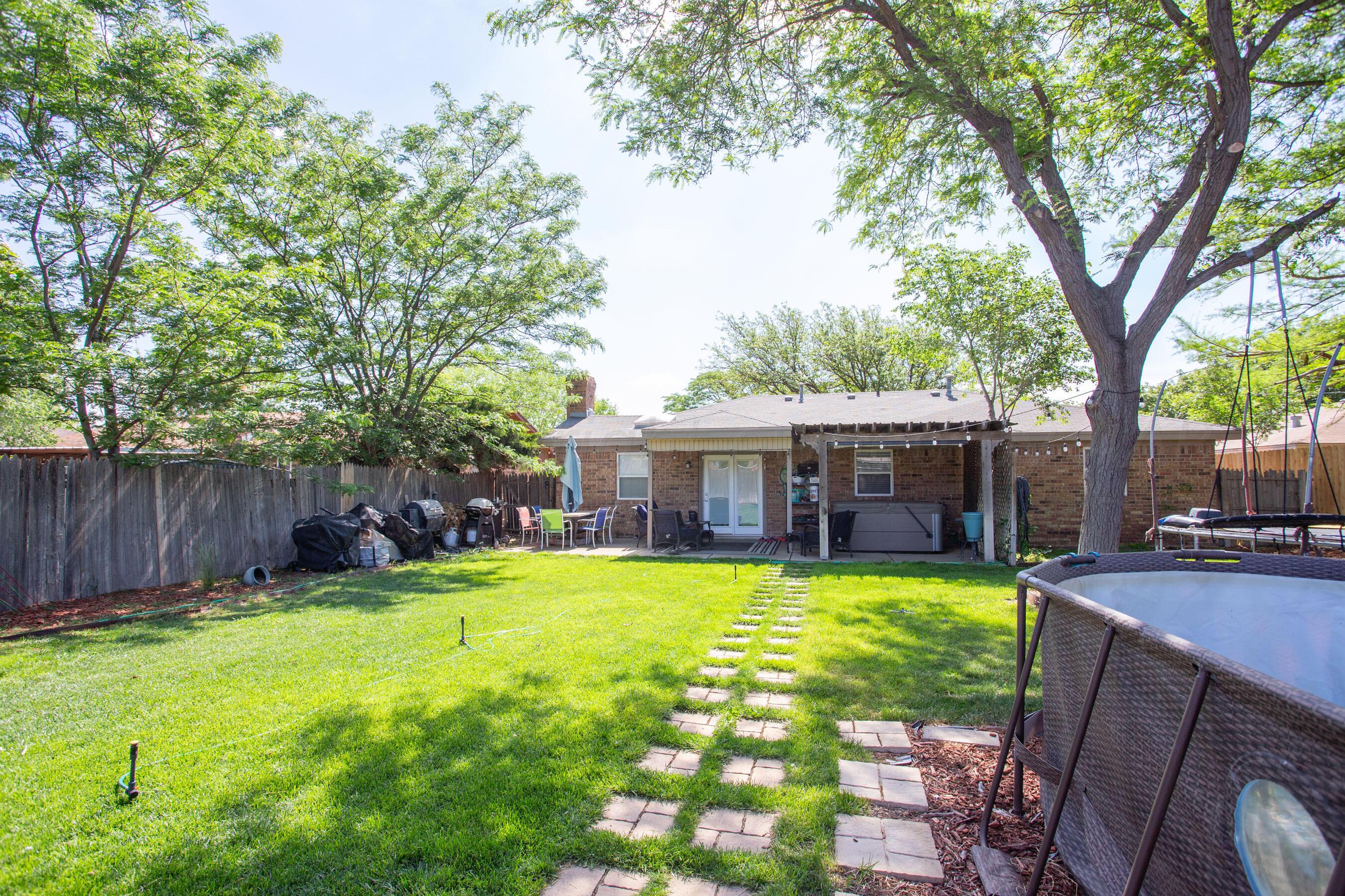 8122 Santa Fe Trail Amarillo, TX 79110 - Photo 22 of 23 a view of a house with swimming pool and sitting area