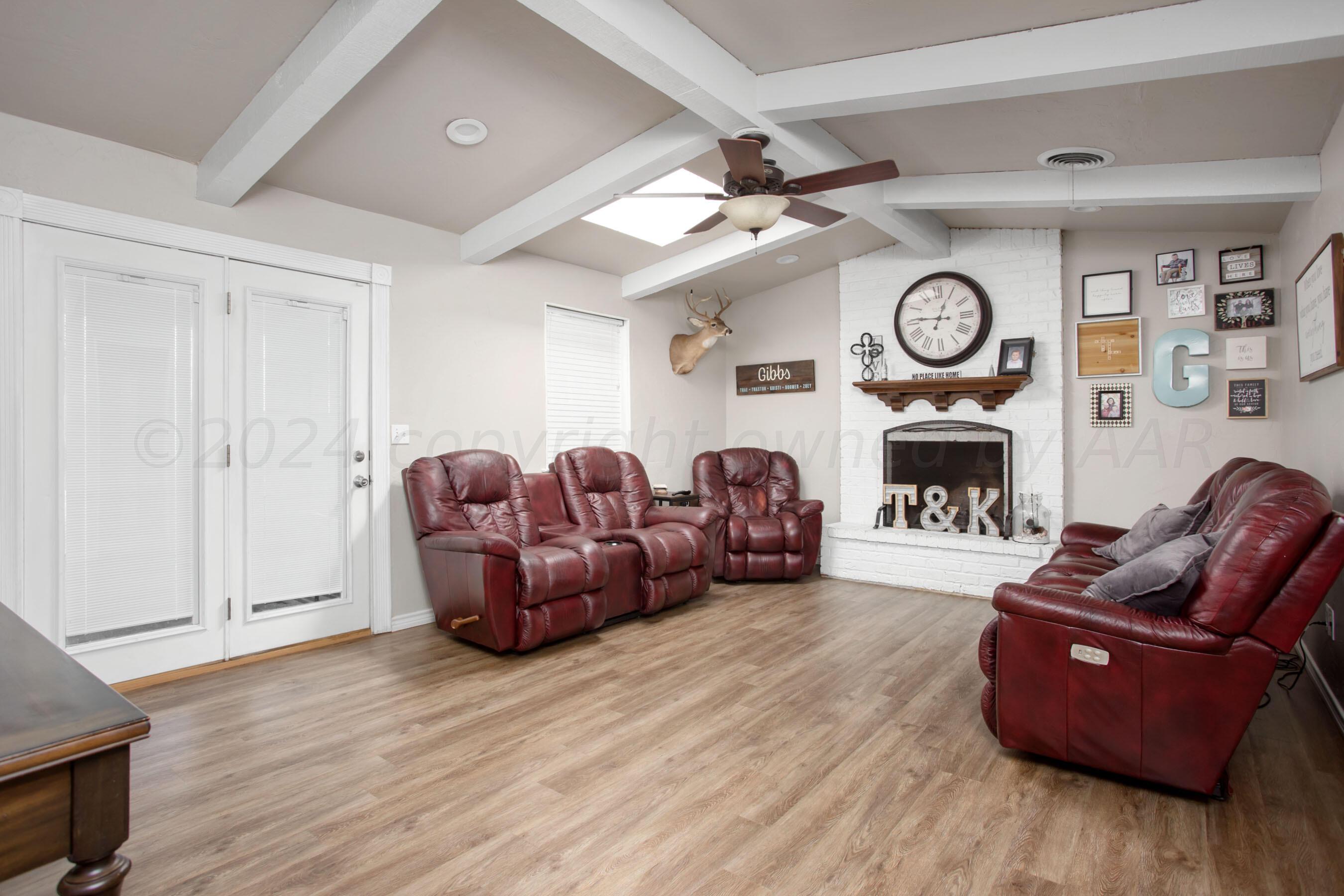 8122 Santa Fe Trail Amarillo, TX 79110 - Photo 4 of 23 a living room with furniture a clock and a fireplace