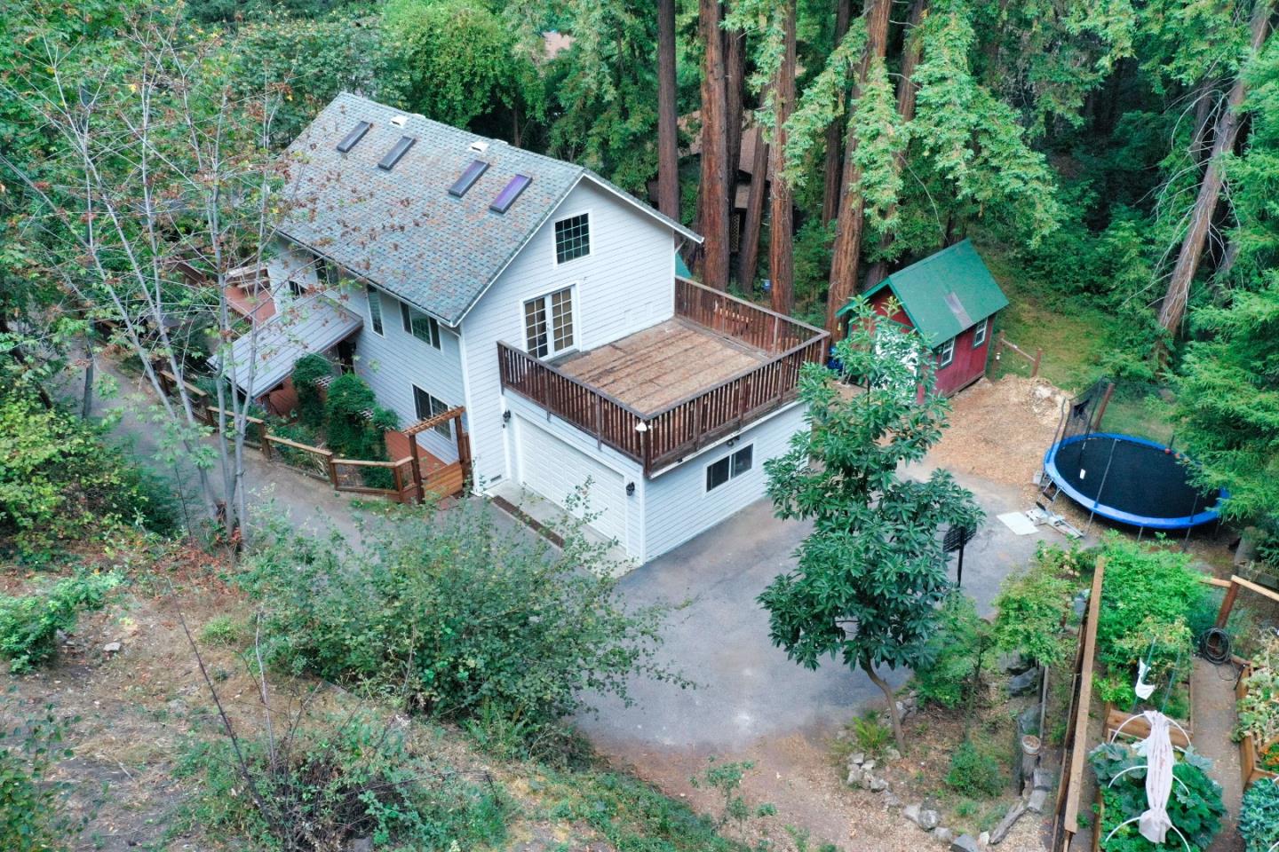 an aerial view of a house with garden space and street view