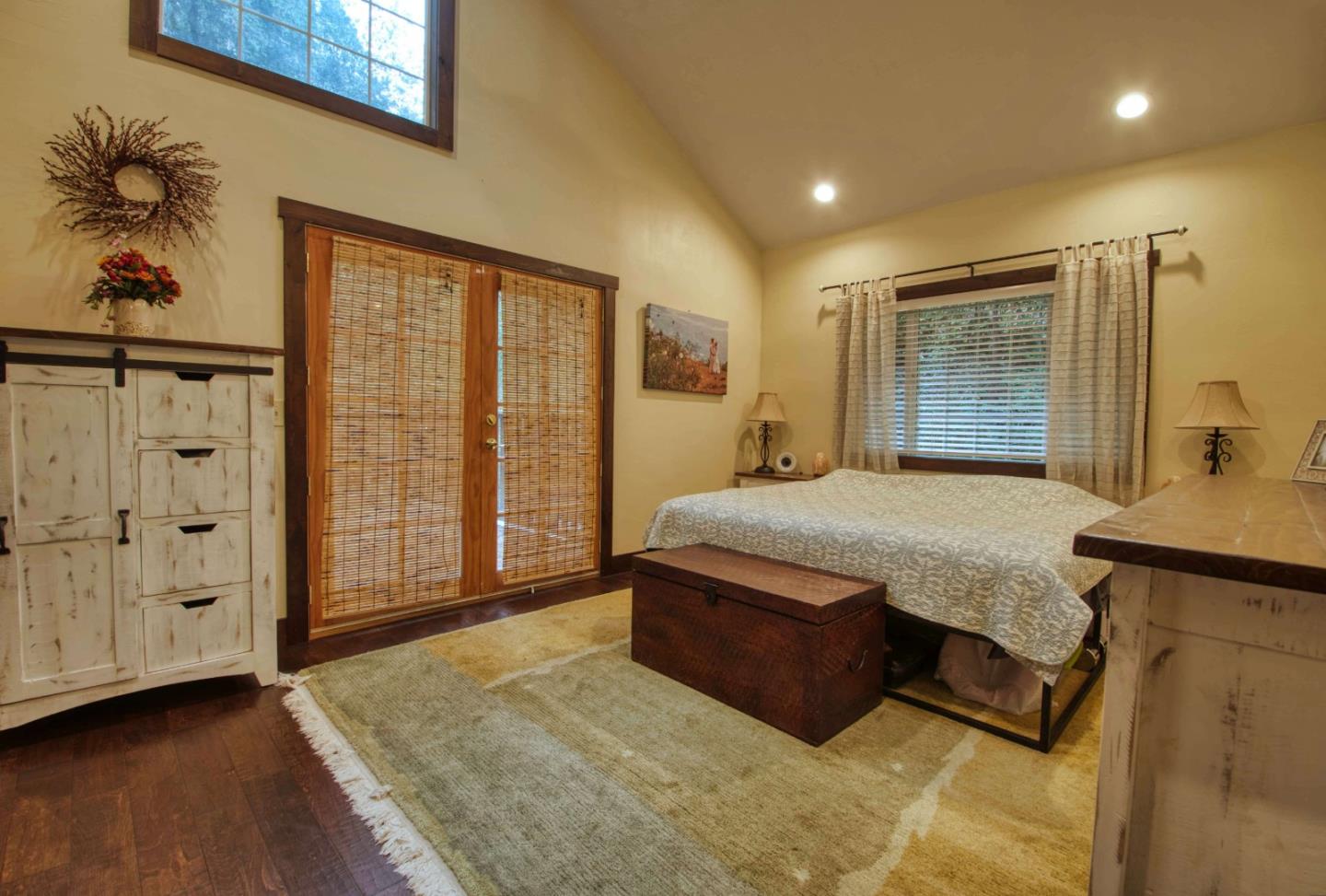 Long Ridge Road Los Gatos, CA 95033 - Photo 11 of 30 a bedroom with a large bed and a chandelier