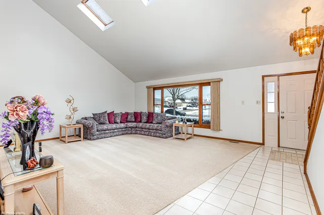 a view of a livingroom with furniture and a window