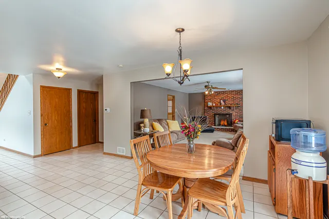 a view of a dining room with furniture and chandelier
