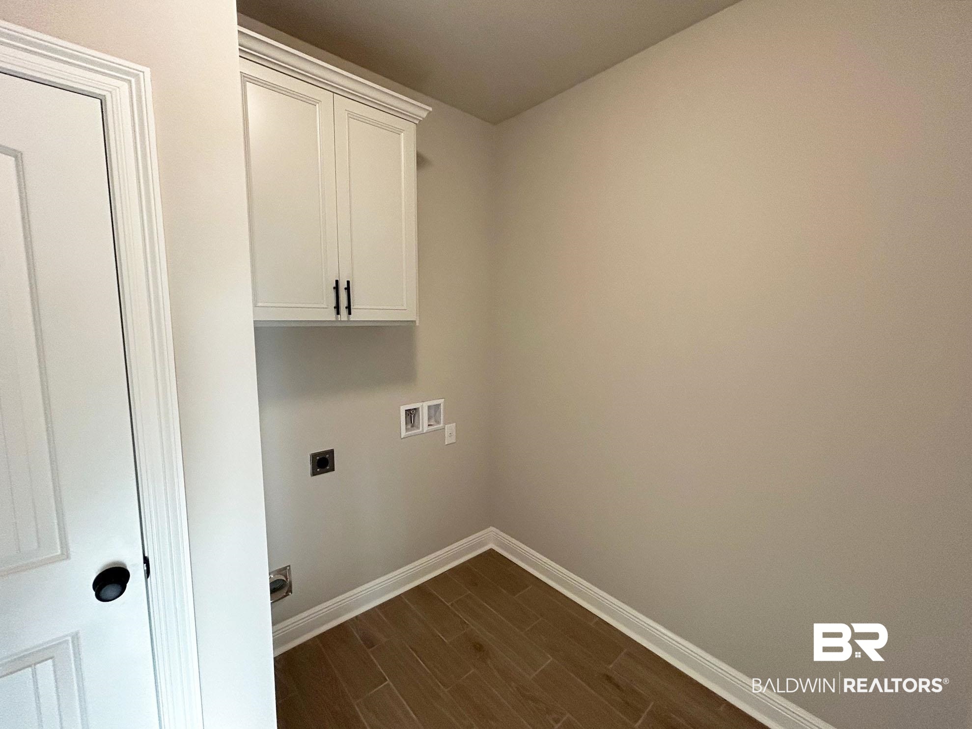 813 Sumter Loop Foley, AL 36535 - Photo 15 of 18 Laundry room with cabinets, washer hookup, dark hardwood / wood-style floors, and electric dryer hookup