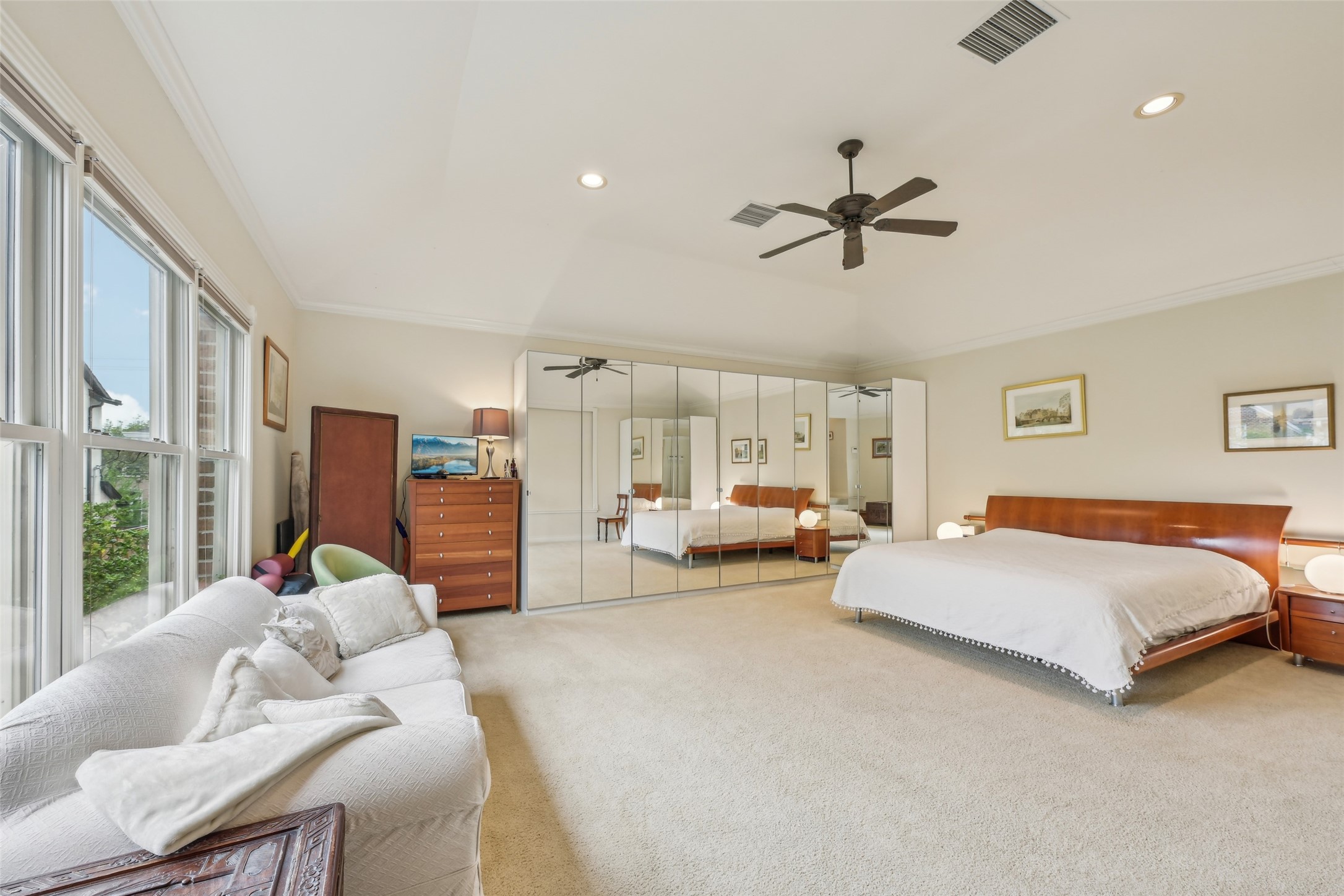 4026 Villanova Street Houston, TX 77005 - Photo 22 of 48 a spacious bedroom with a bed couch and window