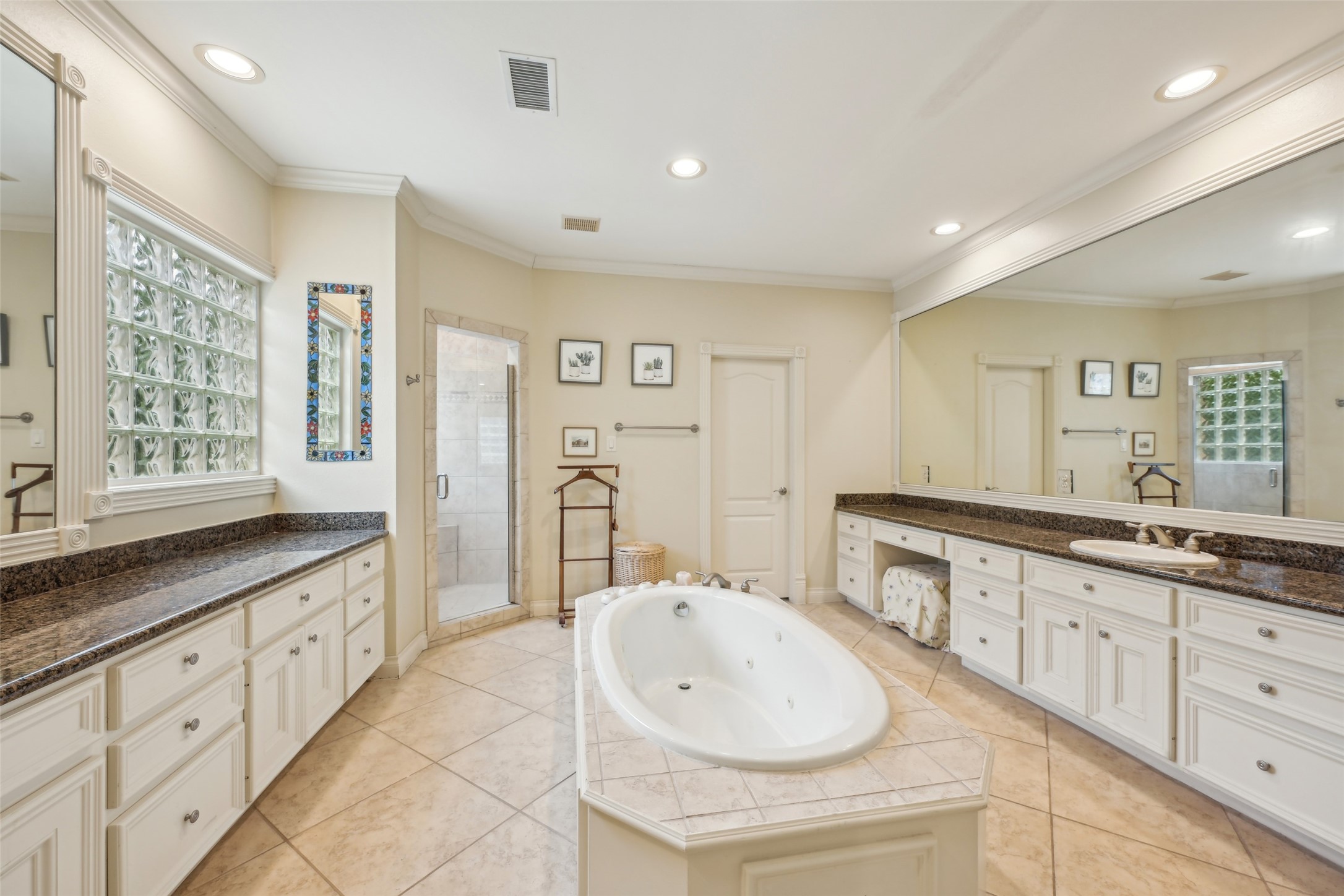 4026 Villanova Street Houston, TX 77005 - Photo 23 of 48 a spacious bathroom with double sink and a bathtub