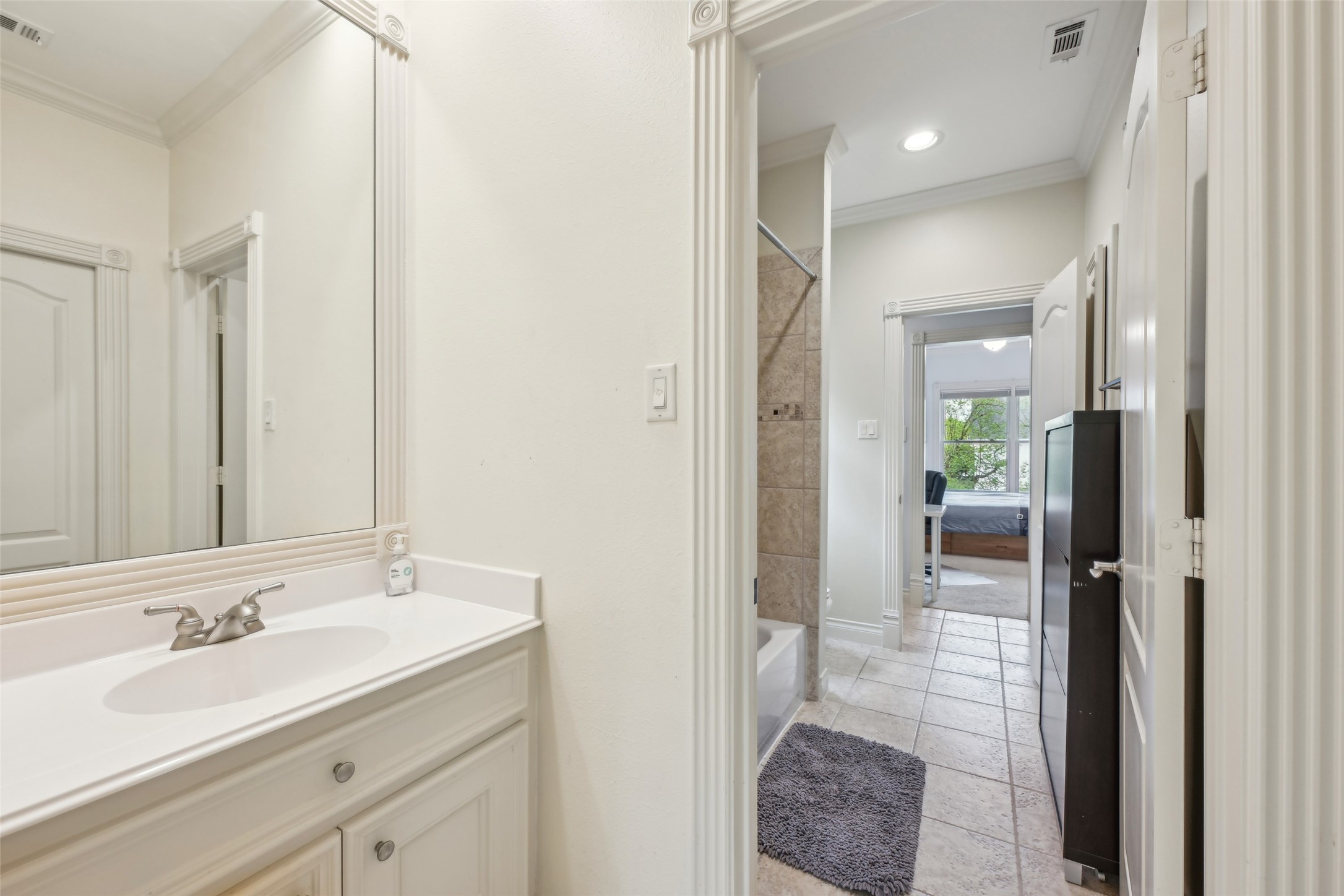 4026 Villanova Street Houston, TX 77005 - Photo 27 of 48 a bathroom with a sink a mirror and a shower