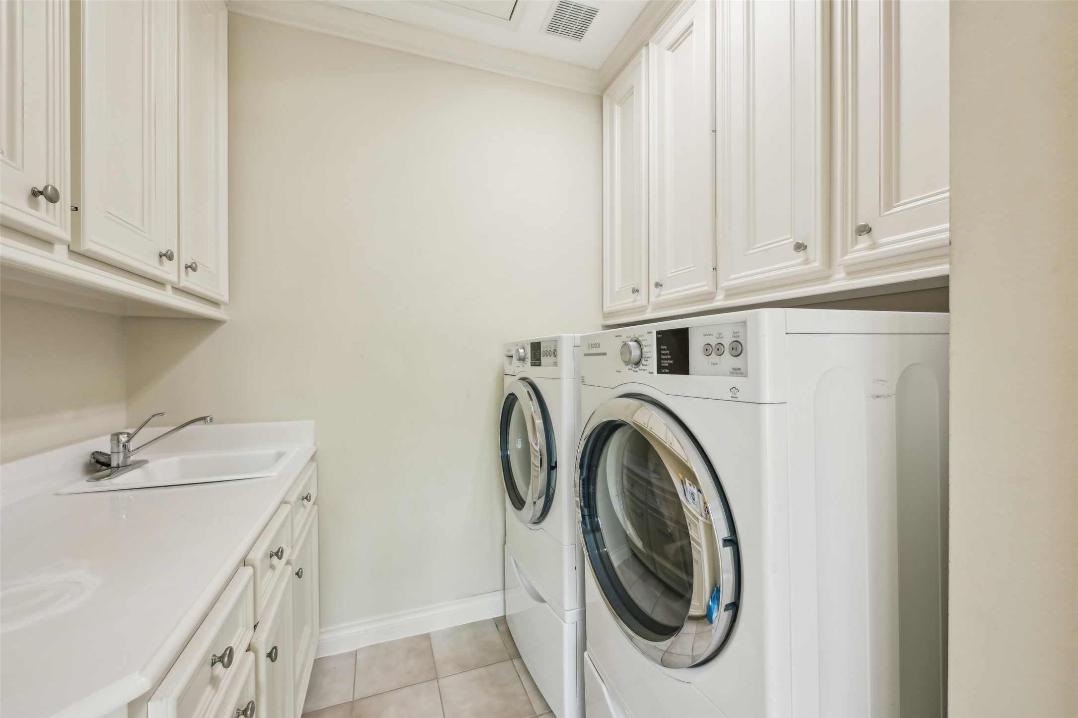 4026 Villanova Street Houston, TX 77005 - Photo 31 of 48 a utility room with sink dryer and washer