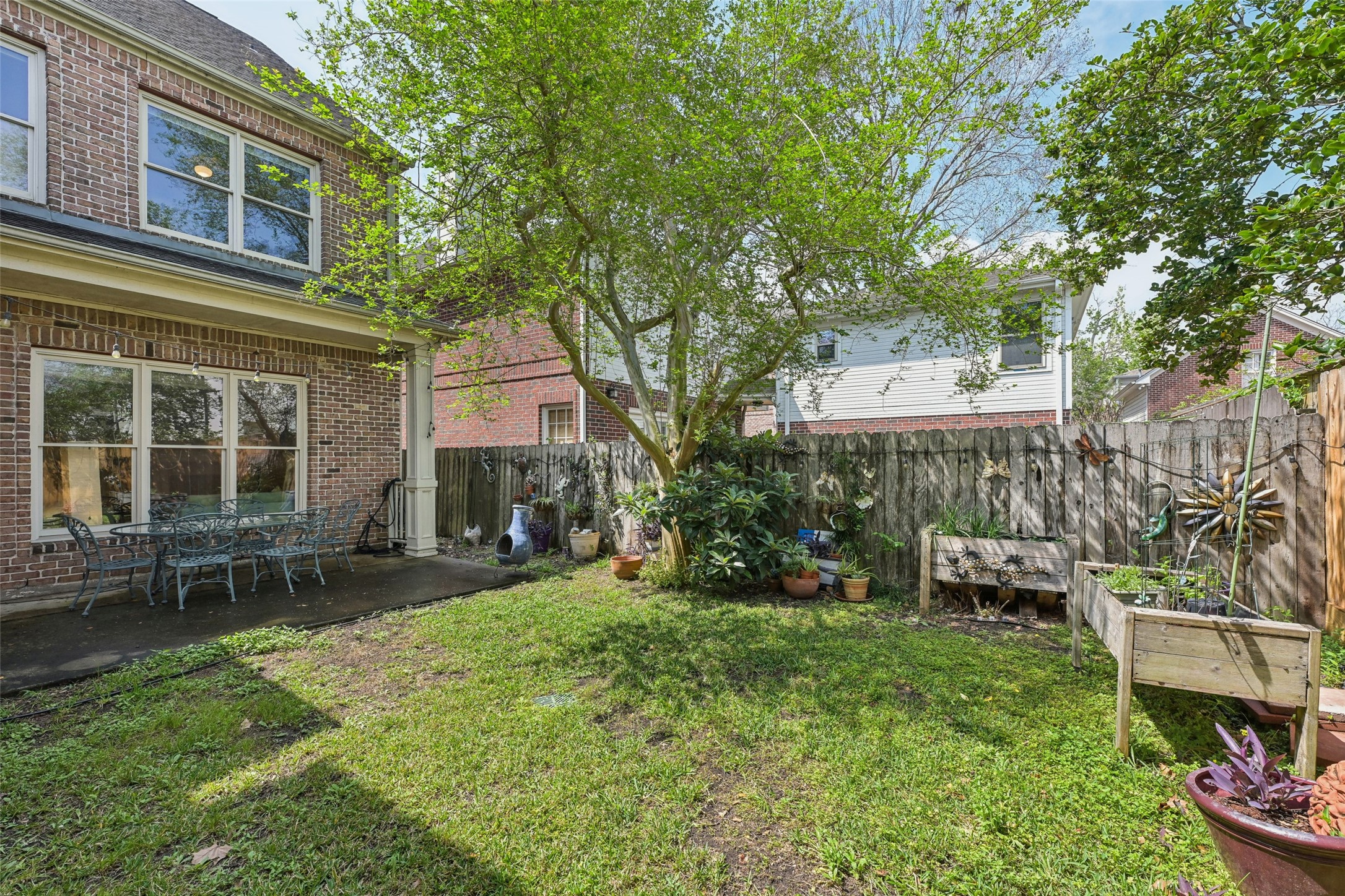 4026 Villanova Street Houston, TX 77005 - Photo 35 of 48 a view of a chair and table in backyard of the house