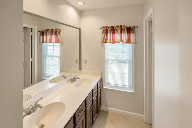 a en suite bathroom with a sink and a mirror