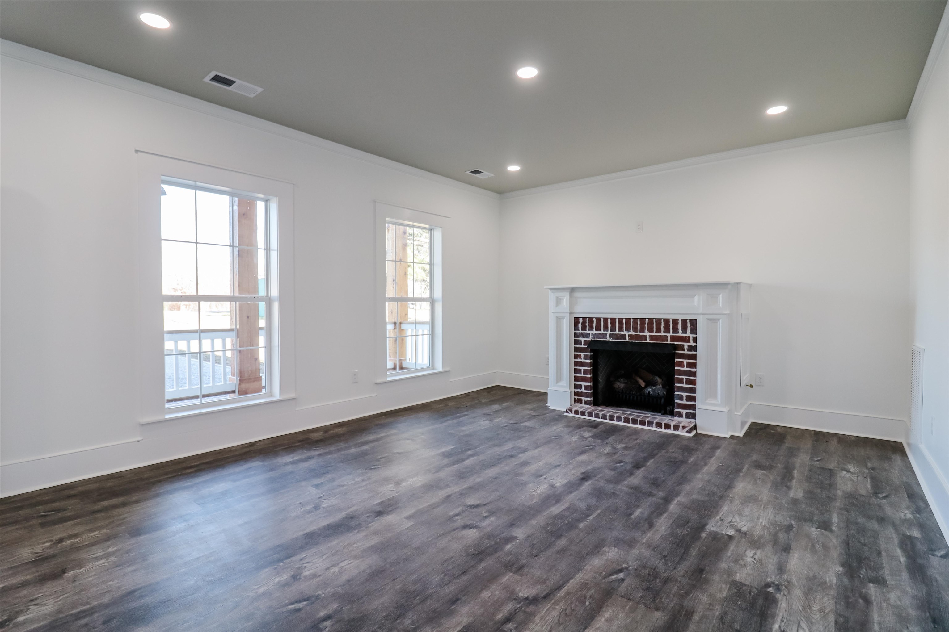 7237 Edith-Nankipoo Road Ripley, TN 38063 - Photo 11 of 31 an empty room with wooden floor fireplace and windows