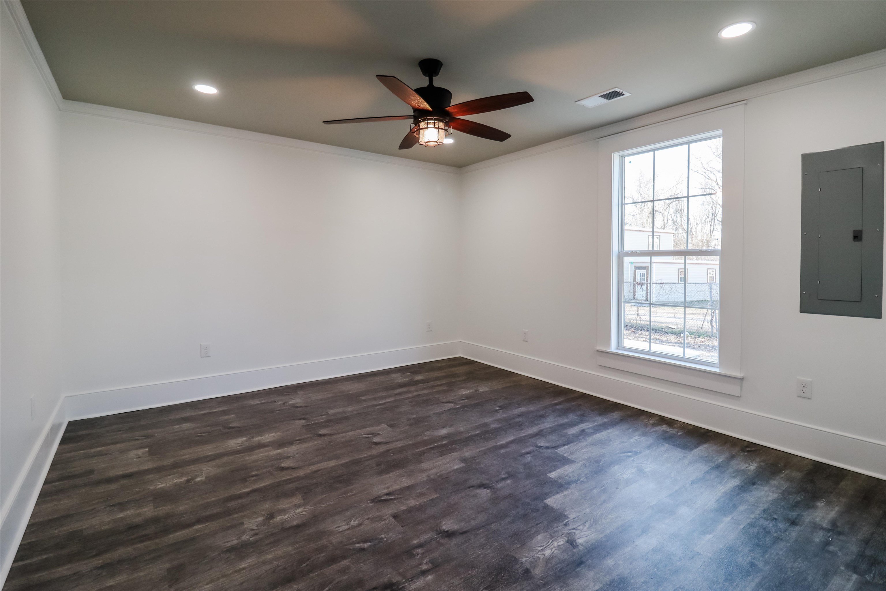 7237 Edith-Nankipoo Road Ripley, TN 38063 - Photo 15 of 31 an empty room with wooden floor fan and windows