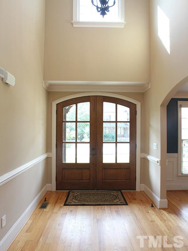 2317 Finley Ridge Lane Raleigh, NC 27615 - Photo 3 of 23 an empty room with wooden floor and windows