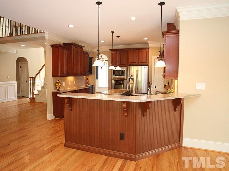 2317 Finley Ridge Lane Raleigh, NC 27615 - Photo 6 of 23 a kitchen with stainless steel appliances granite countertop a sink a stove and a wooden floor