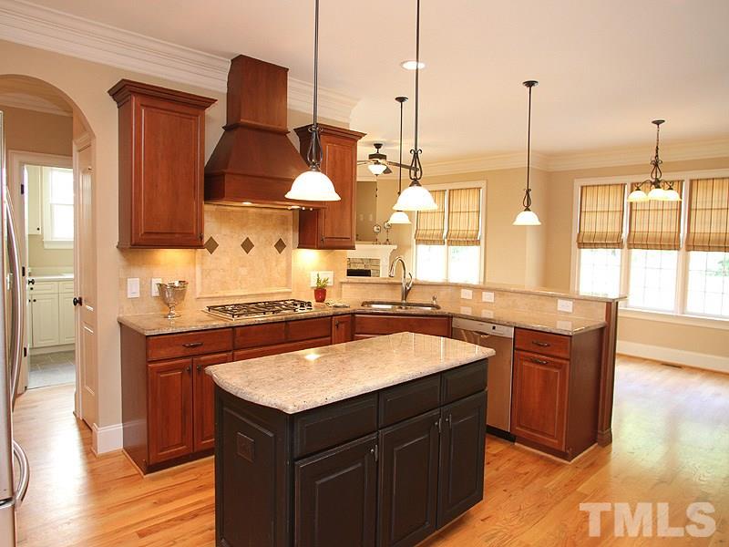 2317 Finley Ridge Lane Raleigh, NC 27615 - Photo 8 of 23 a kitchen with stainless steel appliances granite countertop a sink a stove and a wooden floor