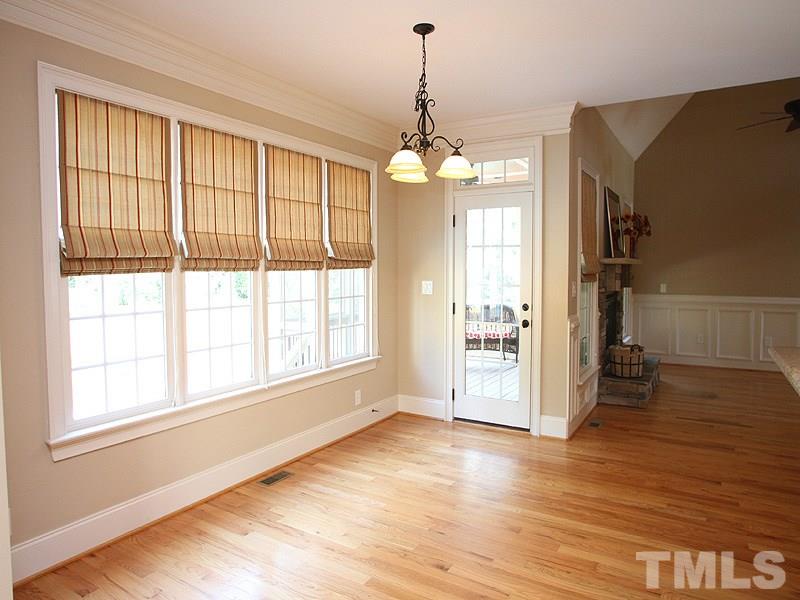 2317 Finley Ridge Lane Raleigh, NC 27615 - Photo 10 of 23 a view of an empty room with wooden floor and a window