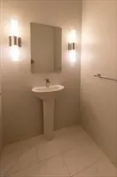 a bathroom with a sink a toilet and mirror