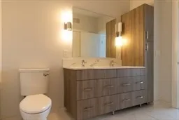 a bathroom with a sink a toilet and mirror
