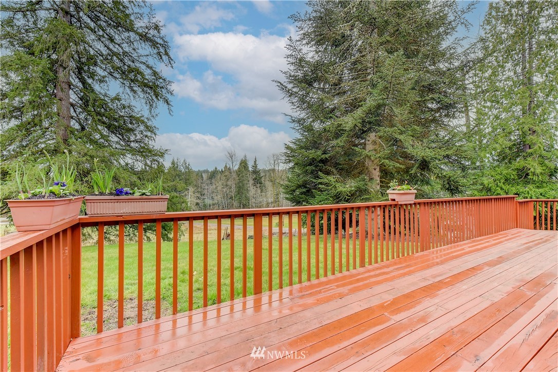 3327 Walsh Road Snohomish, WA 98290 - Photo 3 of 37 a balcony with wooden floor and wooden fence