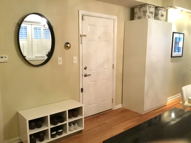 a view of a room with wooden floor and white walls