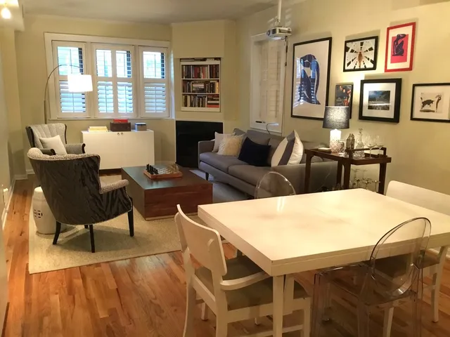 a living room with furniture a table and chair