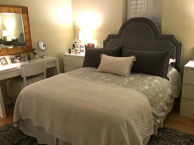 a bed room with two beds and a mirror