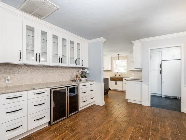 a kitchen with white cabinets and white appliances