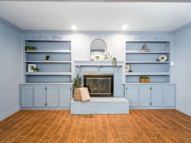 a view of a kitchen with cabinets and a fireplace