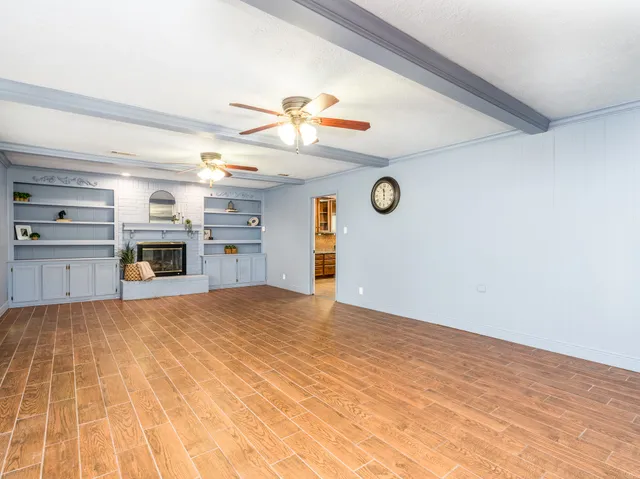 a view of empty room with a fireplace and cabinet
