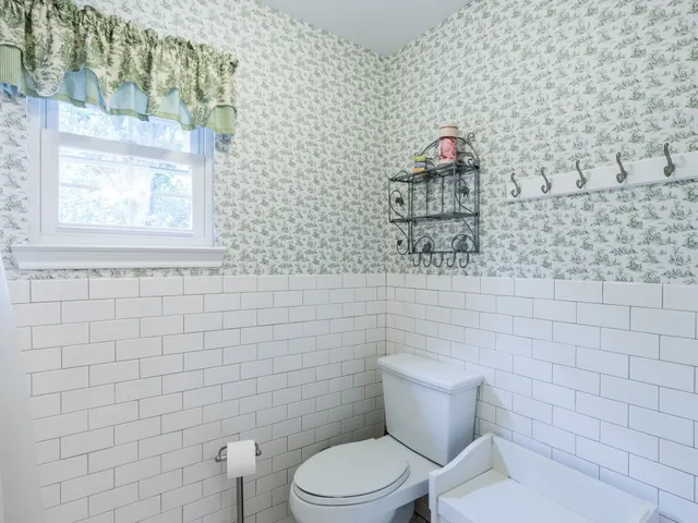 a bathroom with a toilet and a shower curtain