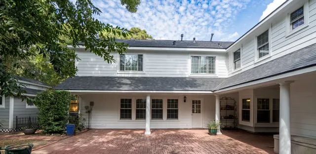 a front view of a house with a garden