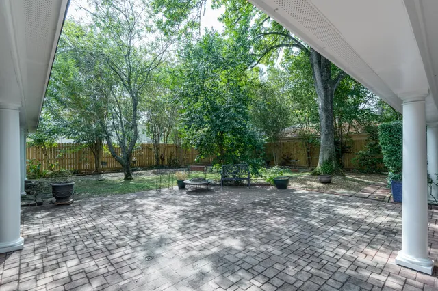 a view of a backyard with large trees