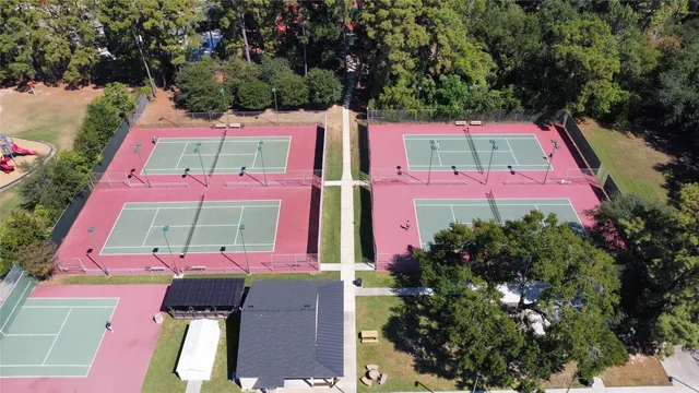 an outdoor space with lots of trees and flowers
