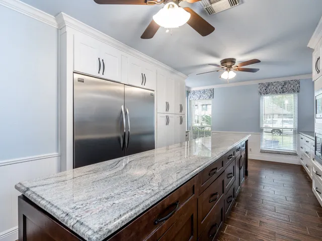 a kitchen with granite countertop a counter space and stainless steel appliances