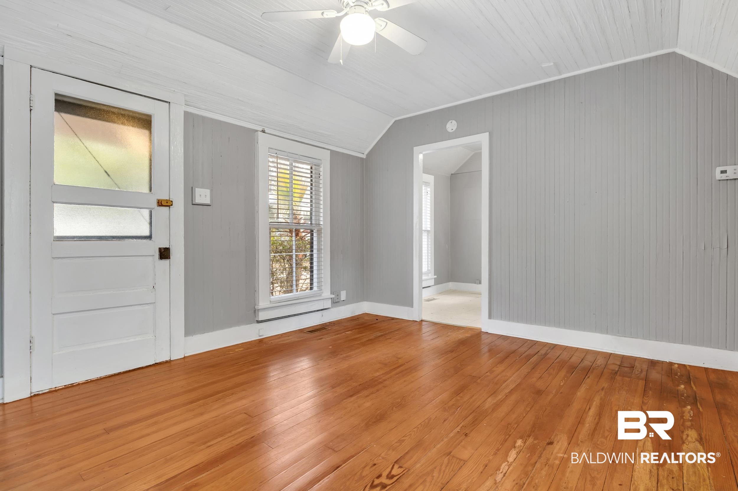 55 Boise Lane Fairhope, AL 36532 - Photo 17 of 24 Living room with wood walls, flooring and ceiling fan