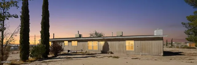 a view of a small house and a yard