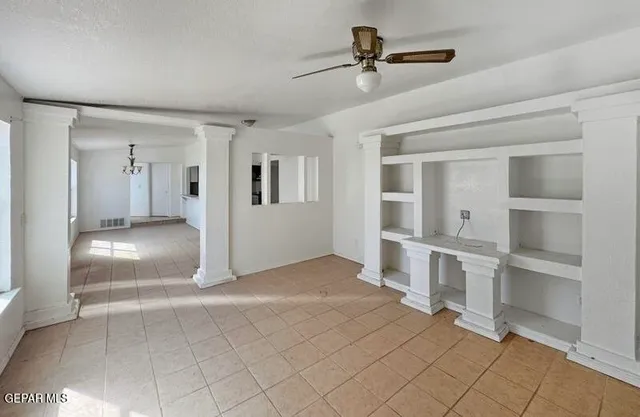 a view of a livingroom with a furniture cabinets and window