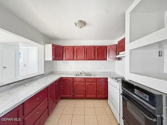 a kitchen with a sink and cabinets