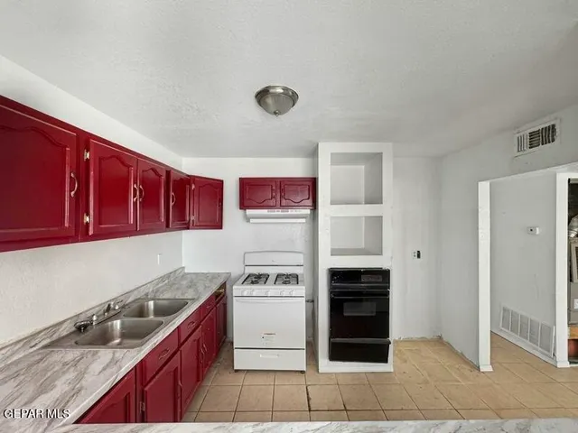 a kitchen with stainless steel appliances granite countertop a stove and a refrigerator