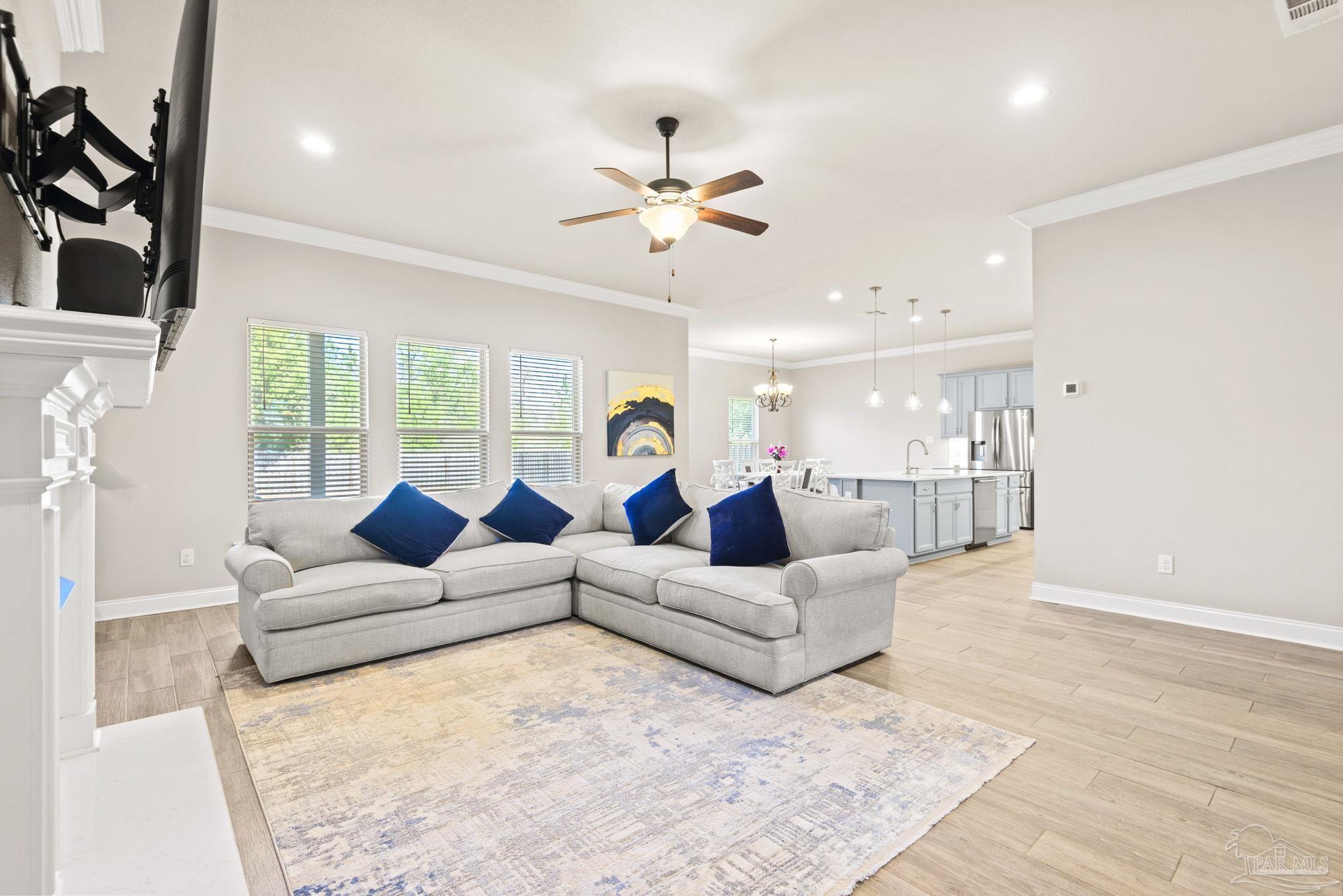 5912 Walter Franklin Road Pensacola, FL 32526 - Photo 11 of 51 a living room with couches a fireplace and a flat screen tv