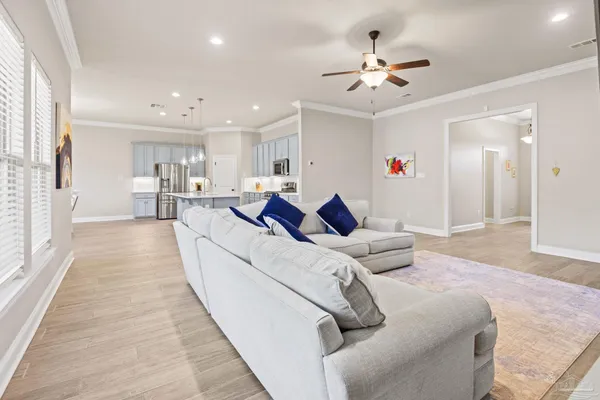a large kitchen with kitchen island a sink a center island stainless steel appliances and a cabinets