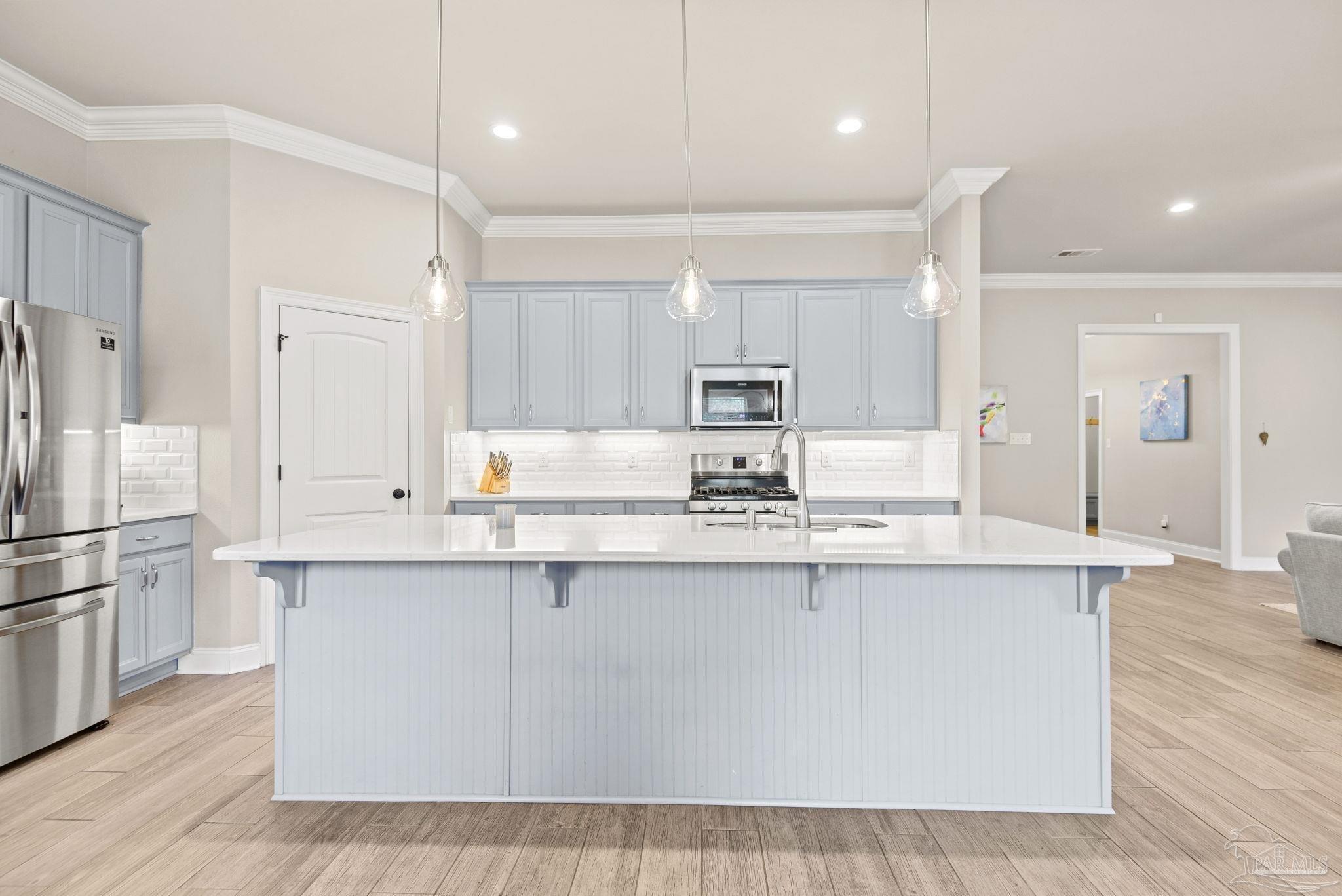 5912 Walter Franklin Road Pensacola, FL 32526 - Photo 15 of 51 a large kitchen with kitchen island a sink a center island stainless steel appliances and a cabinets