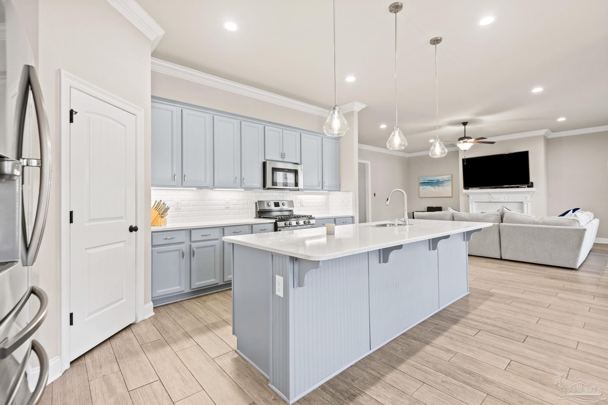 5912 Walter Franklin Road Pensacola, FL 32526 - Photo 16 of 51 a kitchen with a sink cabinets and wooden floor