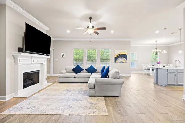 a living room with fireplace furniture and a flat screen tv