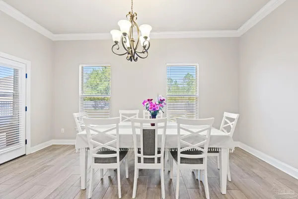 a view of a dining room with furniture and chandelier