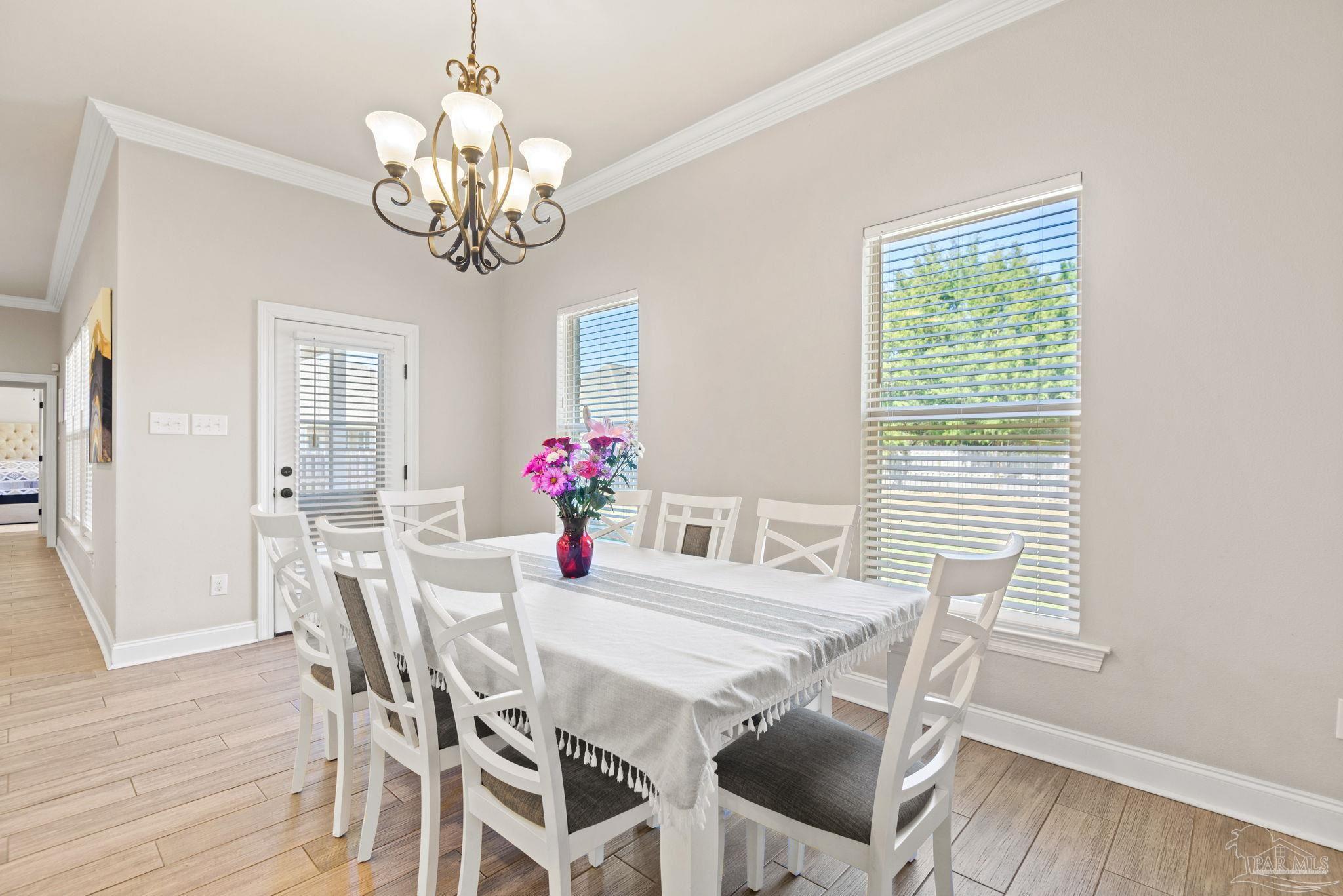 5912 Walter Franklin Road Pensacola, FL 32526 - Photo 22 of 51 a view of a dining room with furniture and chandelier