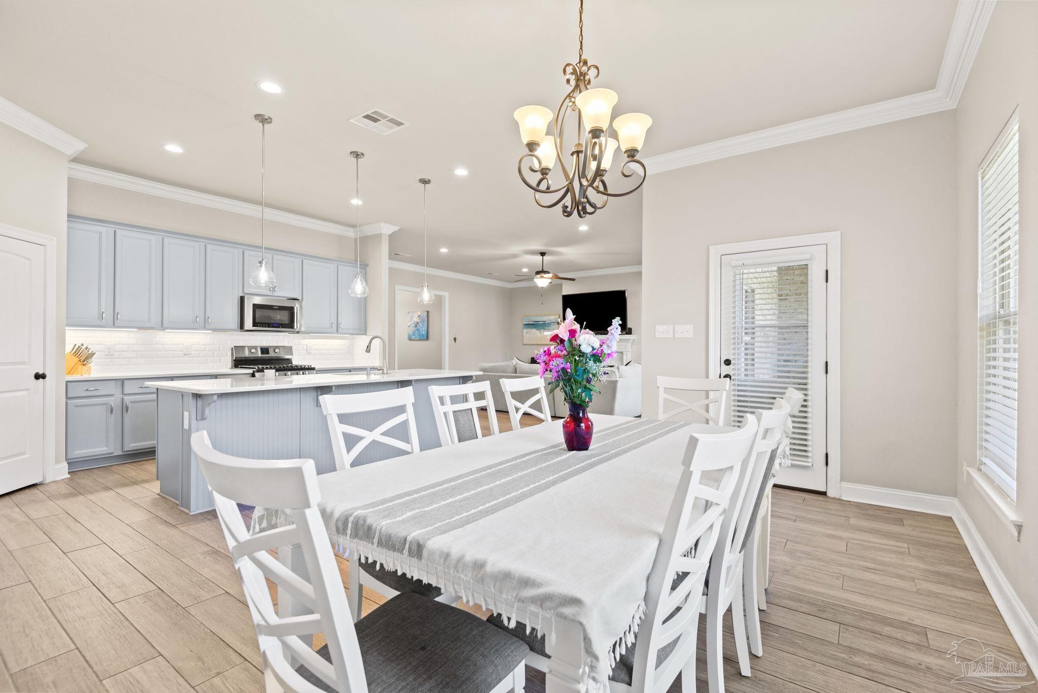 5912 Walter Franklin Road Pensacola, FL 32526 - Photo 23 of 51 a view of a dining room with furniture and chandelier
