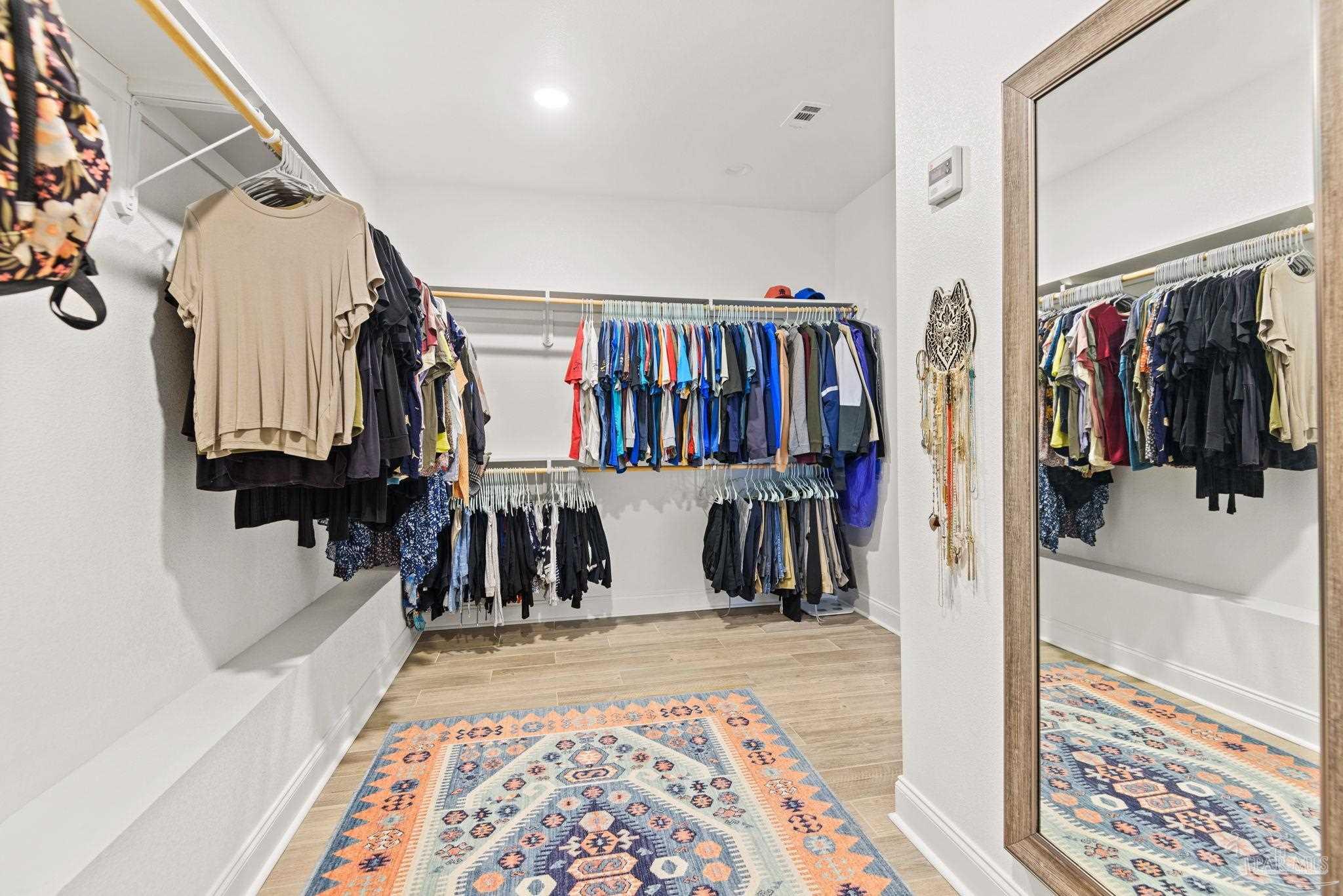 5912 Walter Franklin Road Pensacola, FL 32526 - Photo 30 of 51 a view of walk in closet with clothes and shoes
