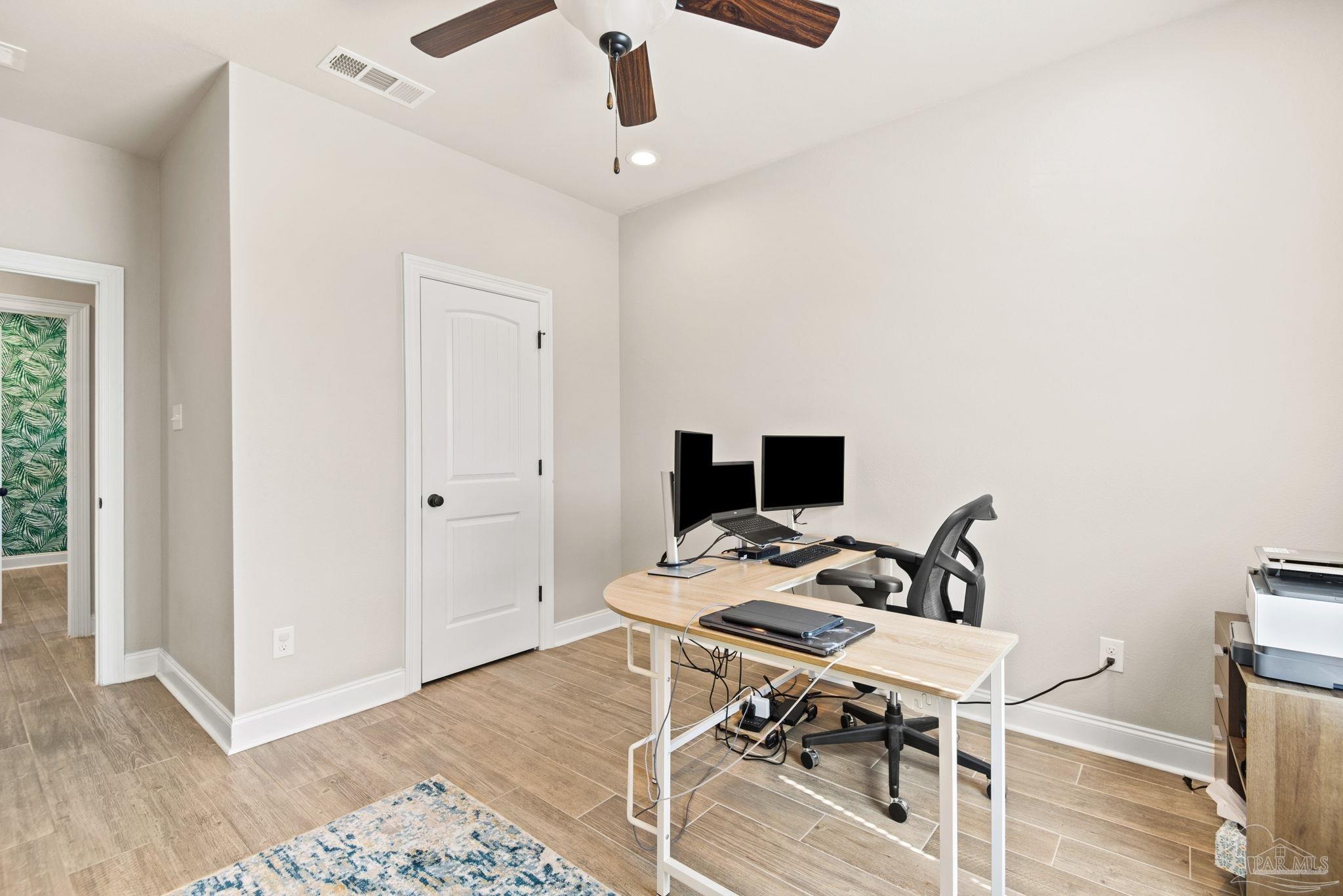 5912 Walter Franklin Road Pensacola, FL 32526 - Photo 32 of 51 a view of a workspace with furniture and wooden floor